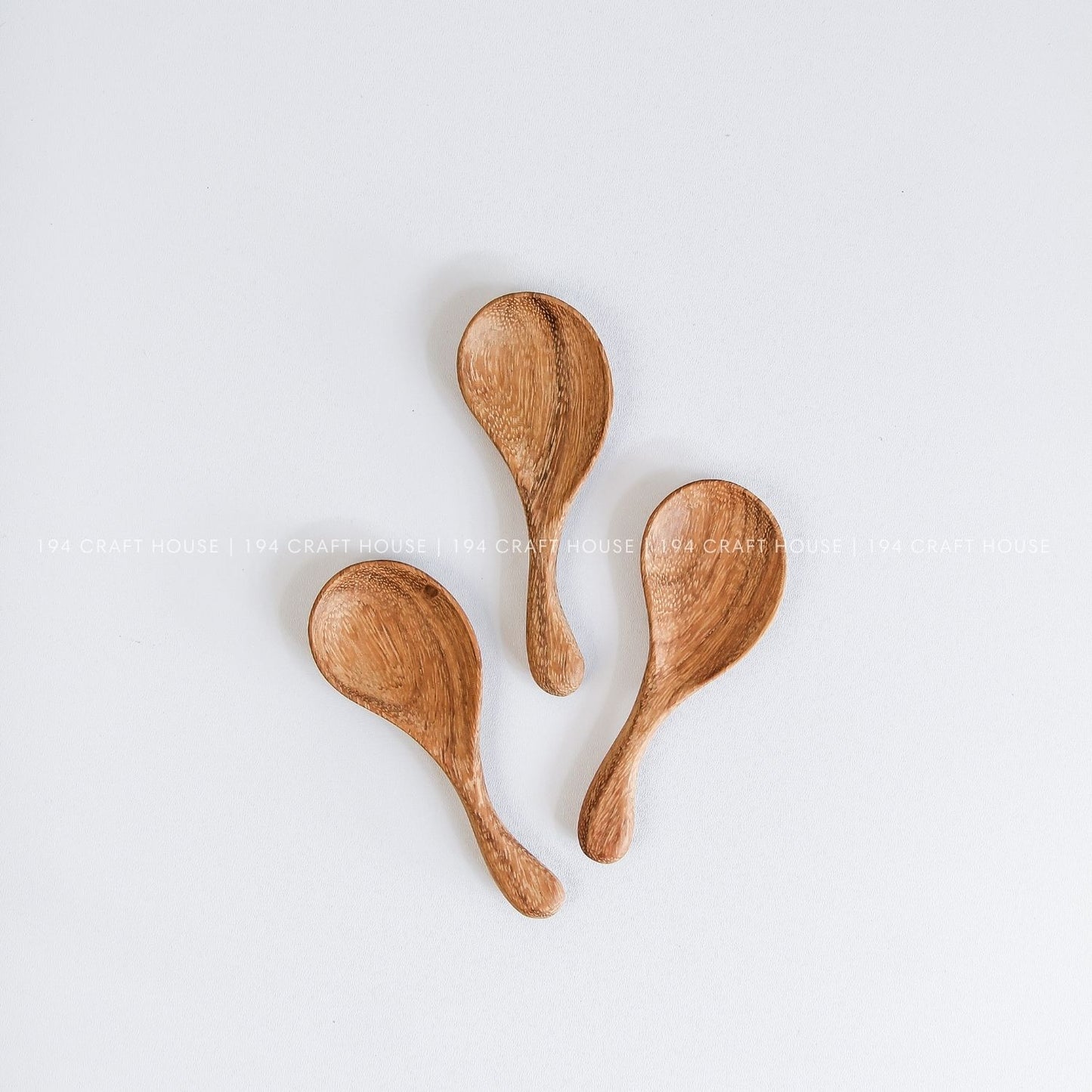 Hand-carved curved short-handle wooden spoons showcasing smooth finishes and natural grain variations