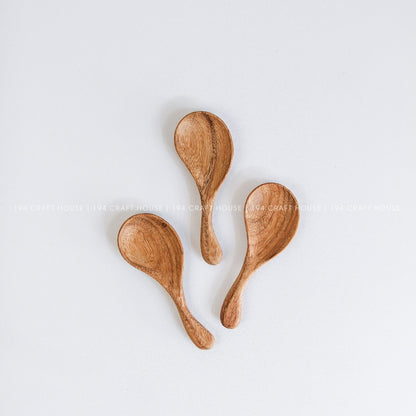 Hand-carved curved short-handle wooden spoons showcasing smooth finishes and natural grain variations