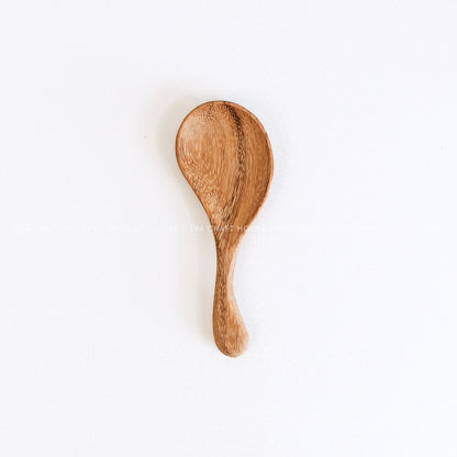 Hand-carved wooden spoon with a curved short handle, smooth finish, and natural wood grain