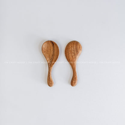 Set of two hand-carved wooden spoons with curved short handles and natural wood grain