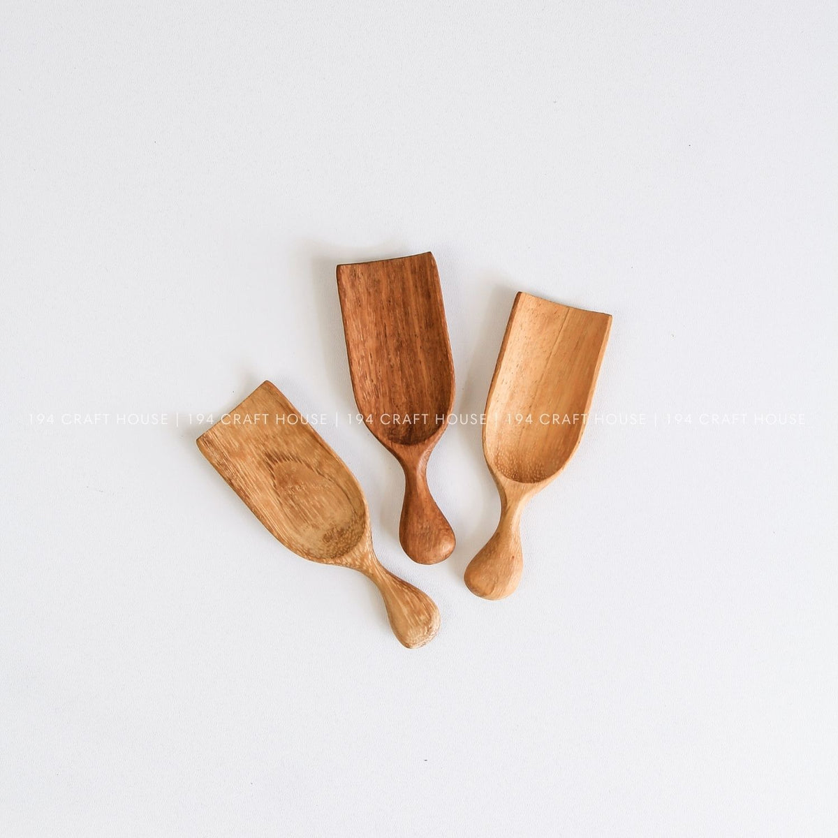 Handcrafted small wooden scoops showcasing smooth finishes and unique natural wood grain variations