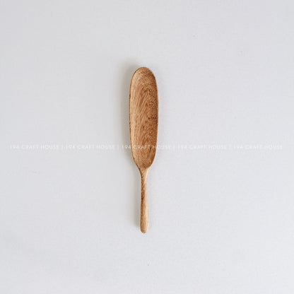 Handcrafted long-handle wooden measuring spoon showcasing its smooth finish and natural wood grain