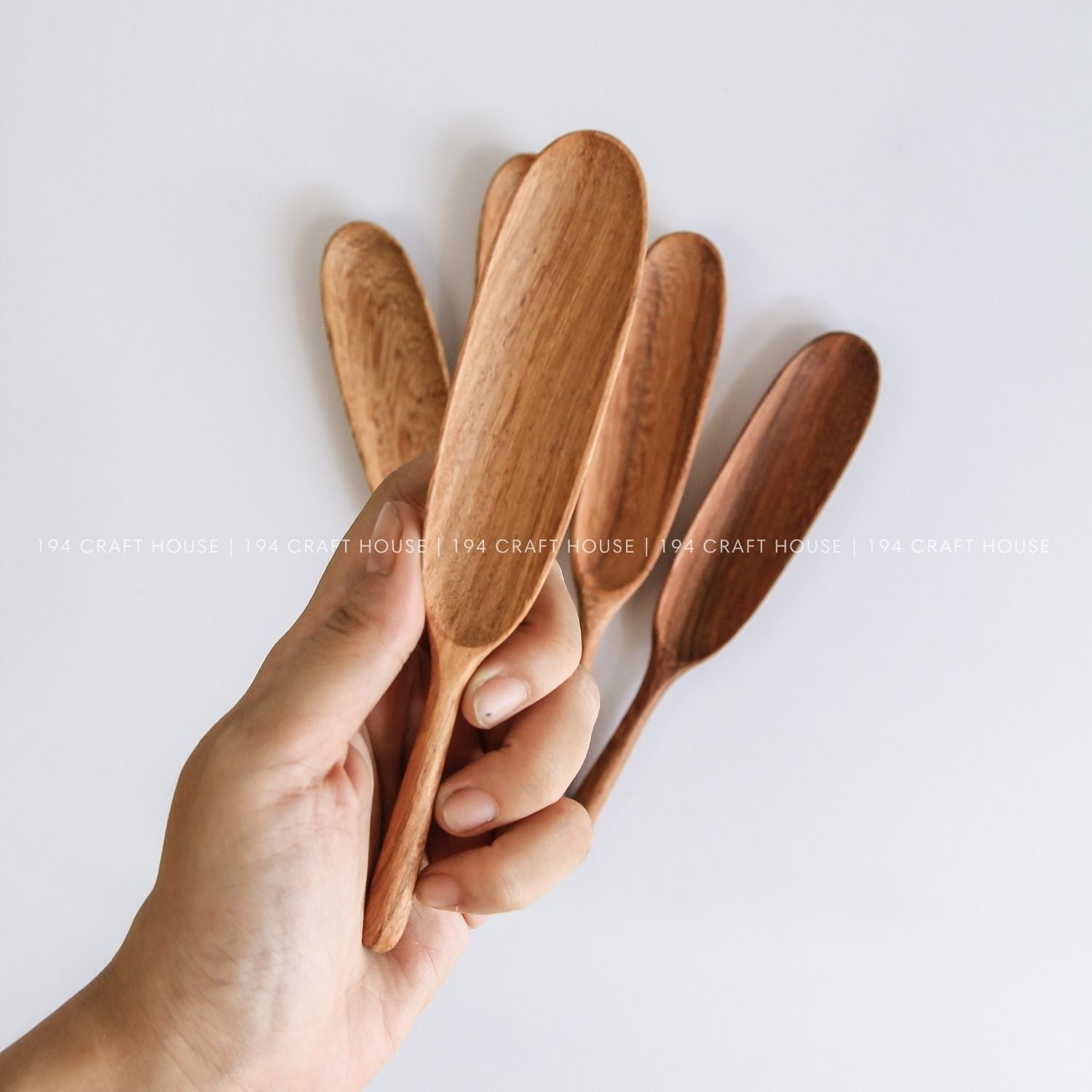 Collection of handcrafted long-handle wooden measuring spoons with smooth natural wood grain
