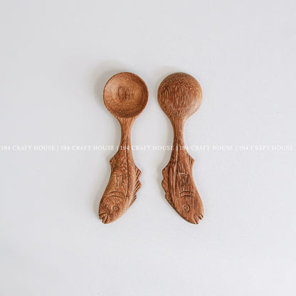 Two handcrafted fish-shaped wooden measuring spoons showcasing natural wood grain and smooth finish