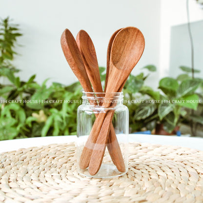 Handcrafted wooden coffee and tea measuring spoons displayed in a natural lifestyle setting