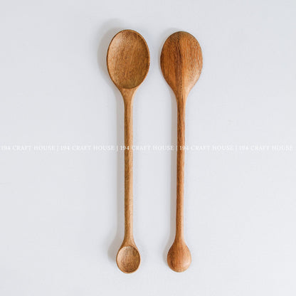 Pair of handcrafted double-ended wooden spoons with natural wood grain