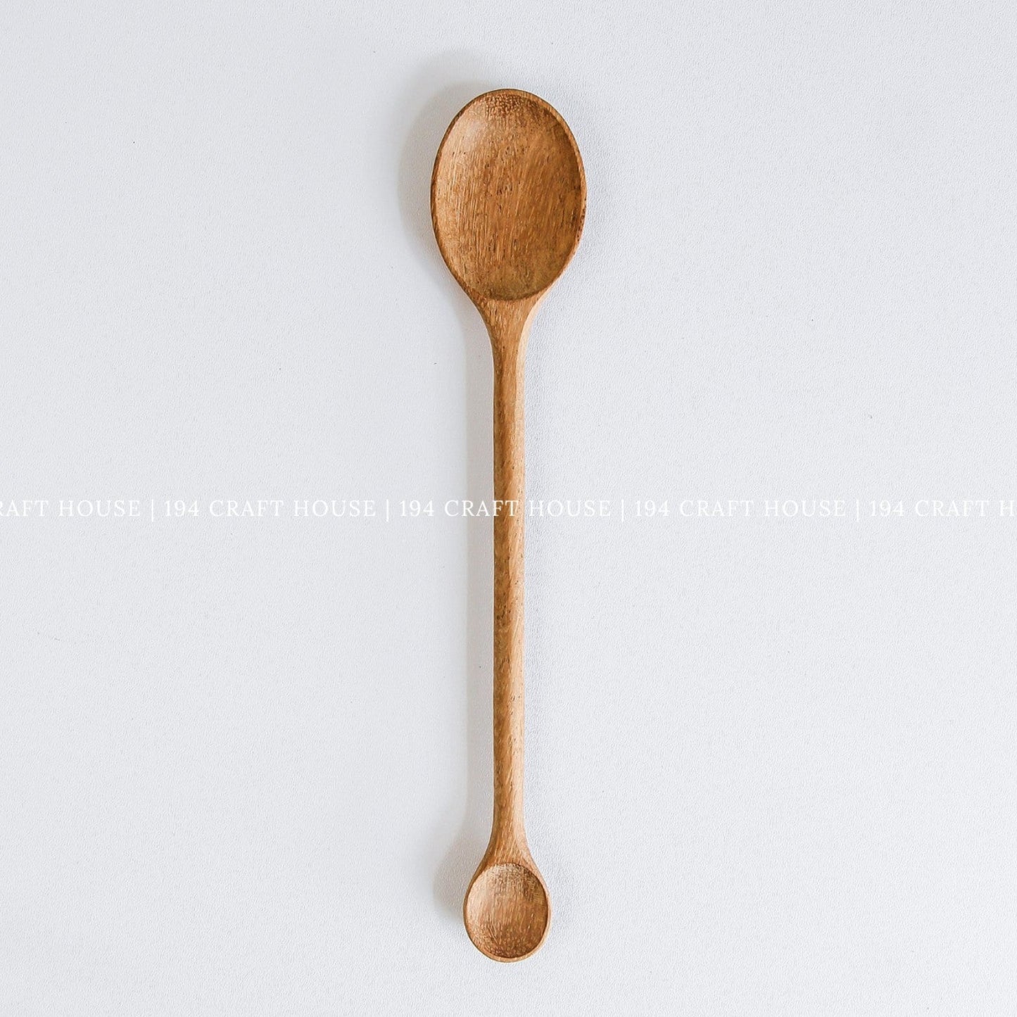 Handcrafted double-ended wooden spoon with large and small spoon bowls
