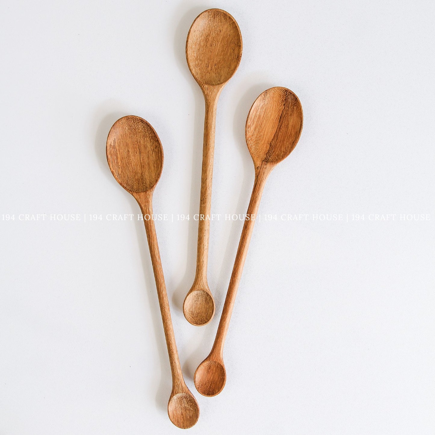 Collection of wooden condiment and serving spoons with double-ended designs