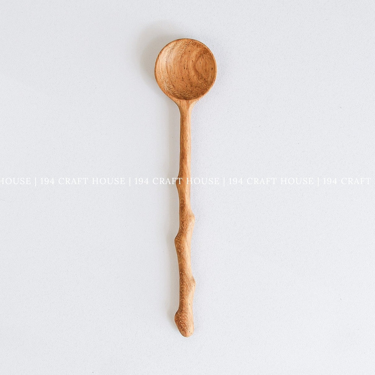 Handcrafted branch tree wooden spoon with a rustic branch-inspired handle and natural wood grain
