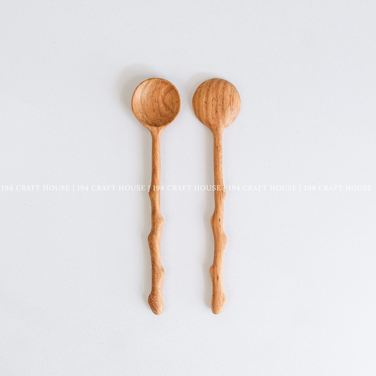 Two handcrafted branch tree wooden spoons with rustic branch-inspired handles