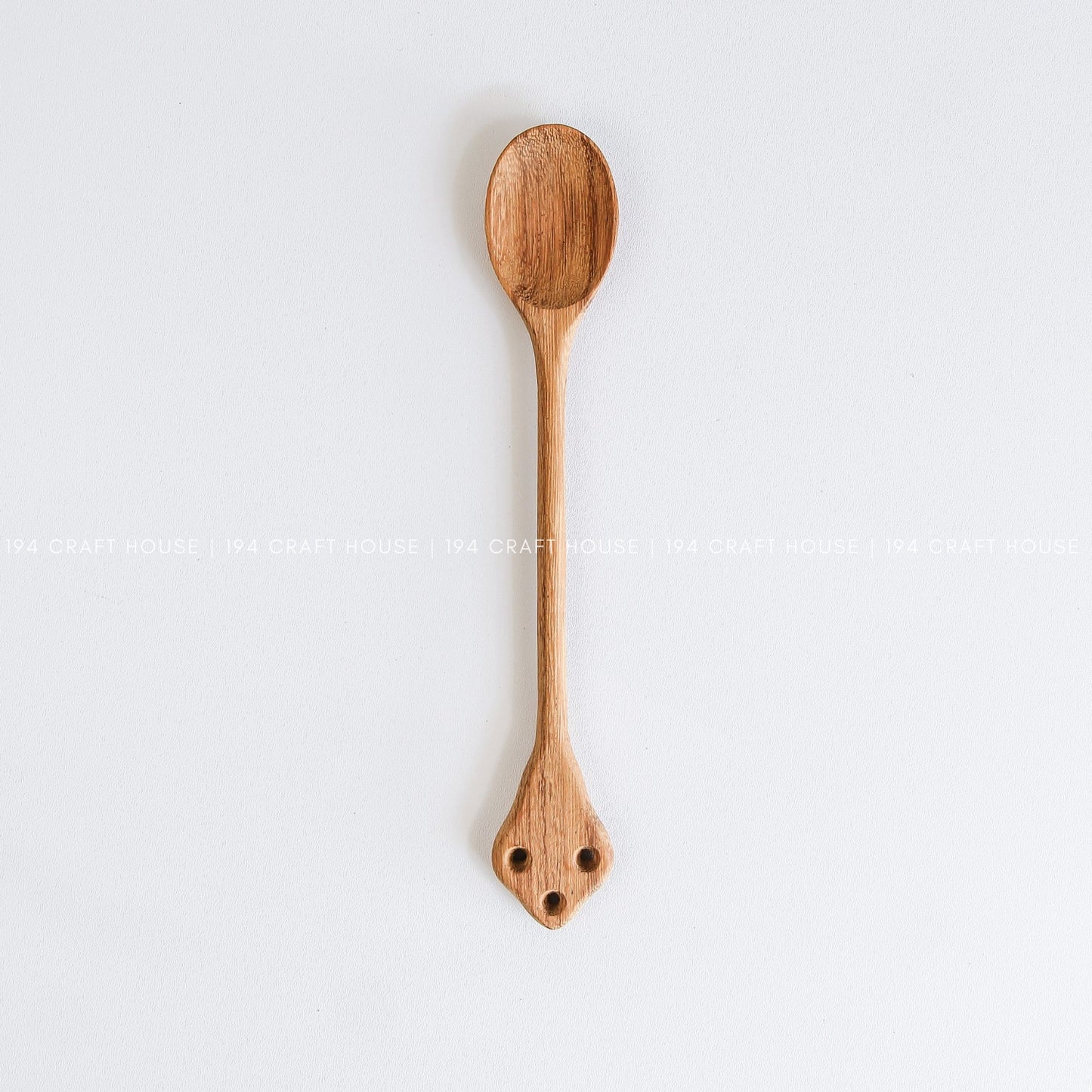 Handcrafted vintage wooden spoon with a classic carved handle and natural wood grain