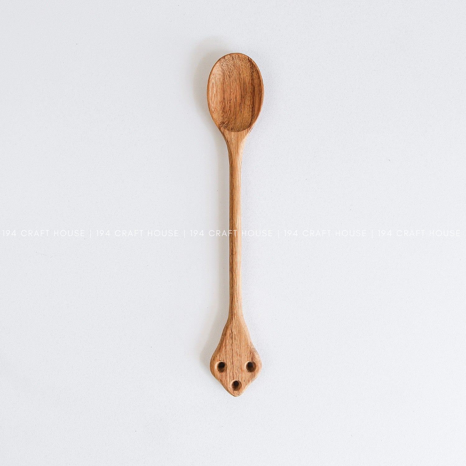 Handcrafted vintage wooden spoon with a classic carved handle and natural wood grain