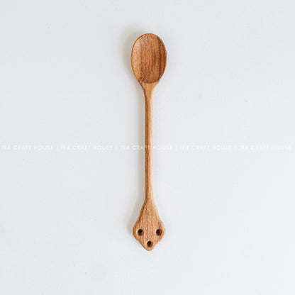 Handcrafted vintage wooden spoon with a classic carved handle and natural wood grain