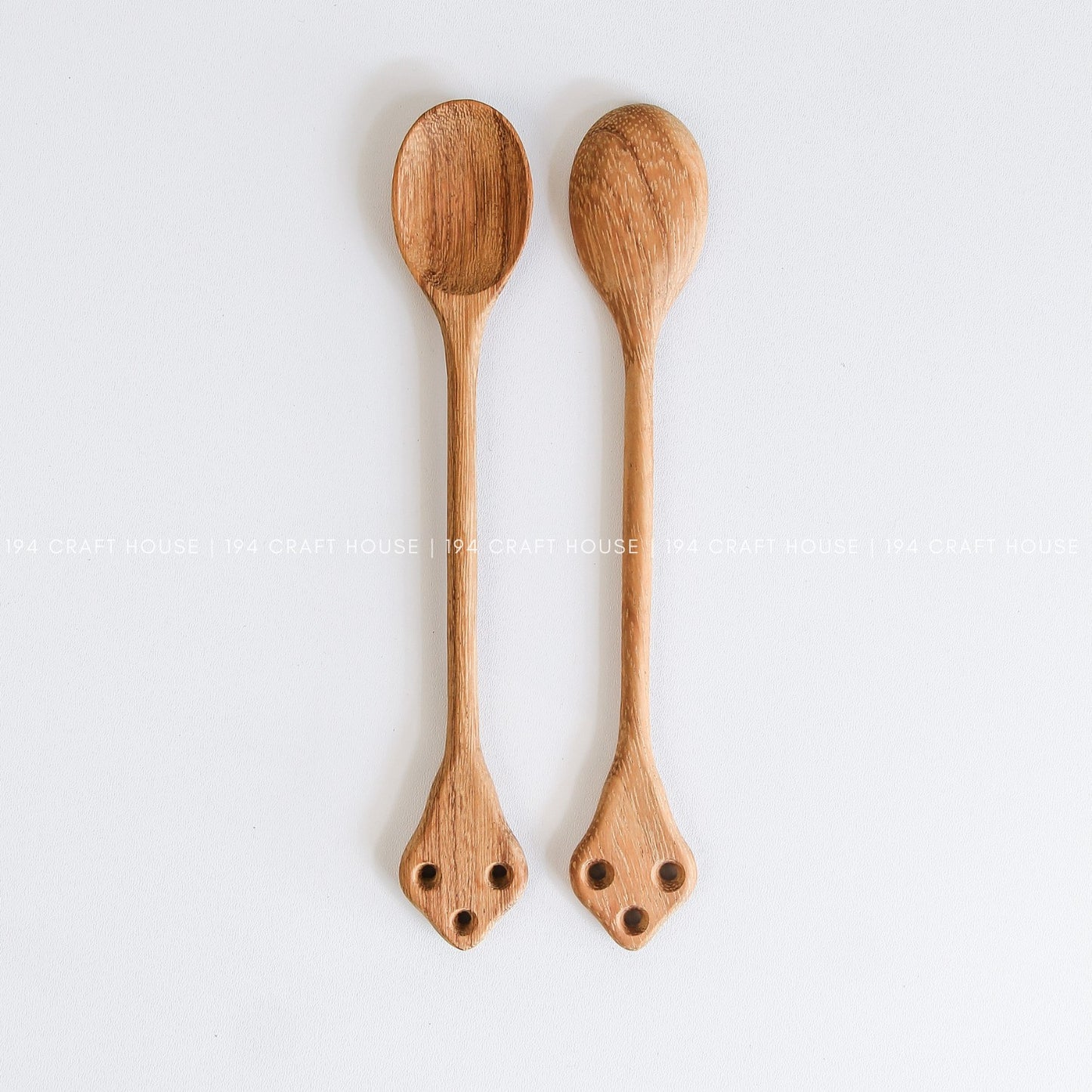 Two handcrafted vintage wooden spoons with classic carved handles