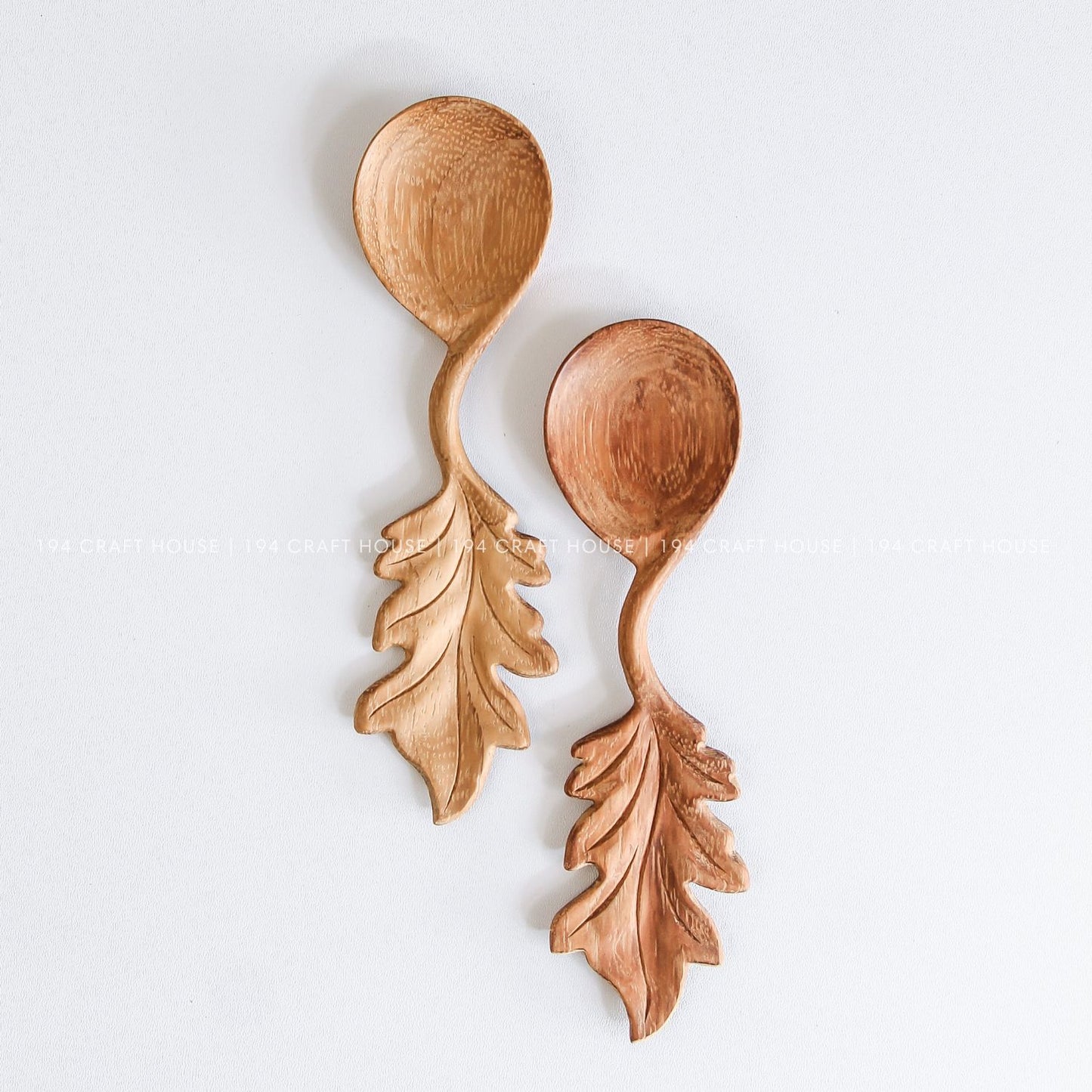 Handcrafted wooden spoons with decorative leaf-shaped handles showcasing natural wood grain variations