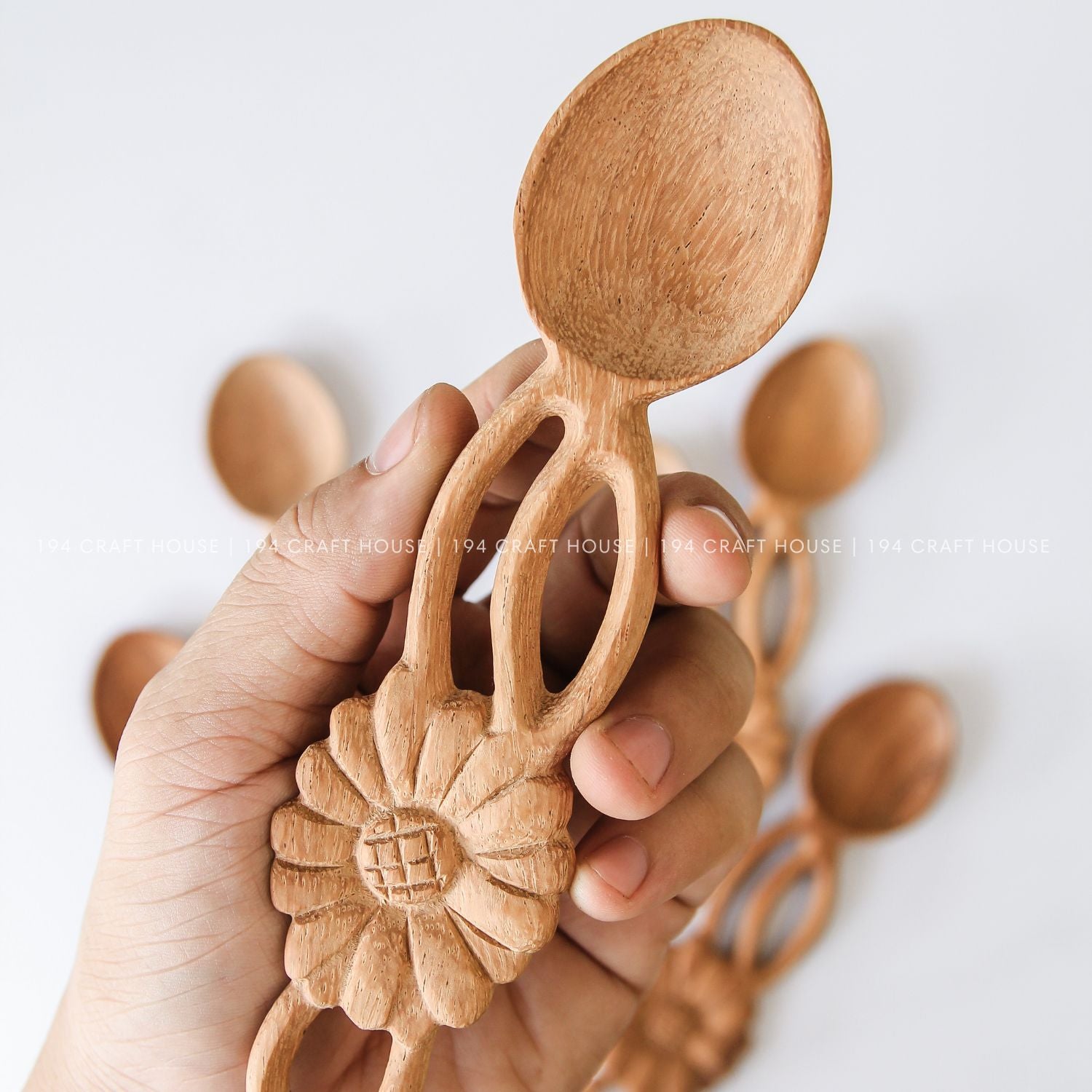 Set of handcrafted wooden spoons with decorative flower-shaped handles and unique natural wood grain