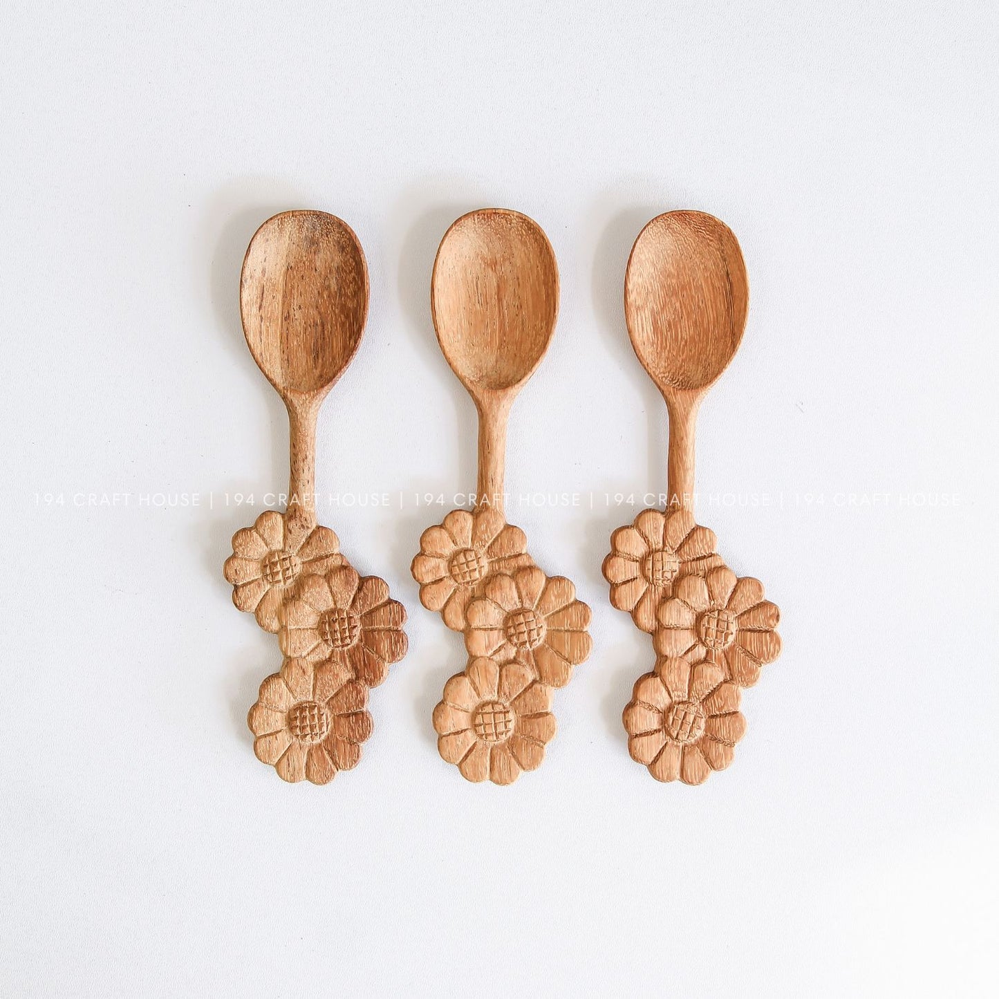 Set of three handcrafted wooden spoons with decorative three-flowers handles