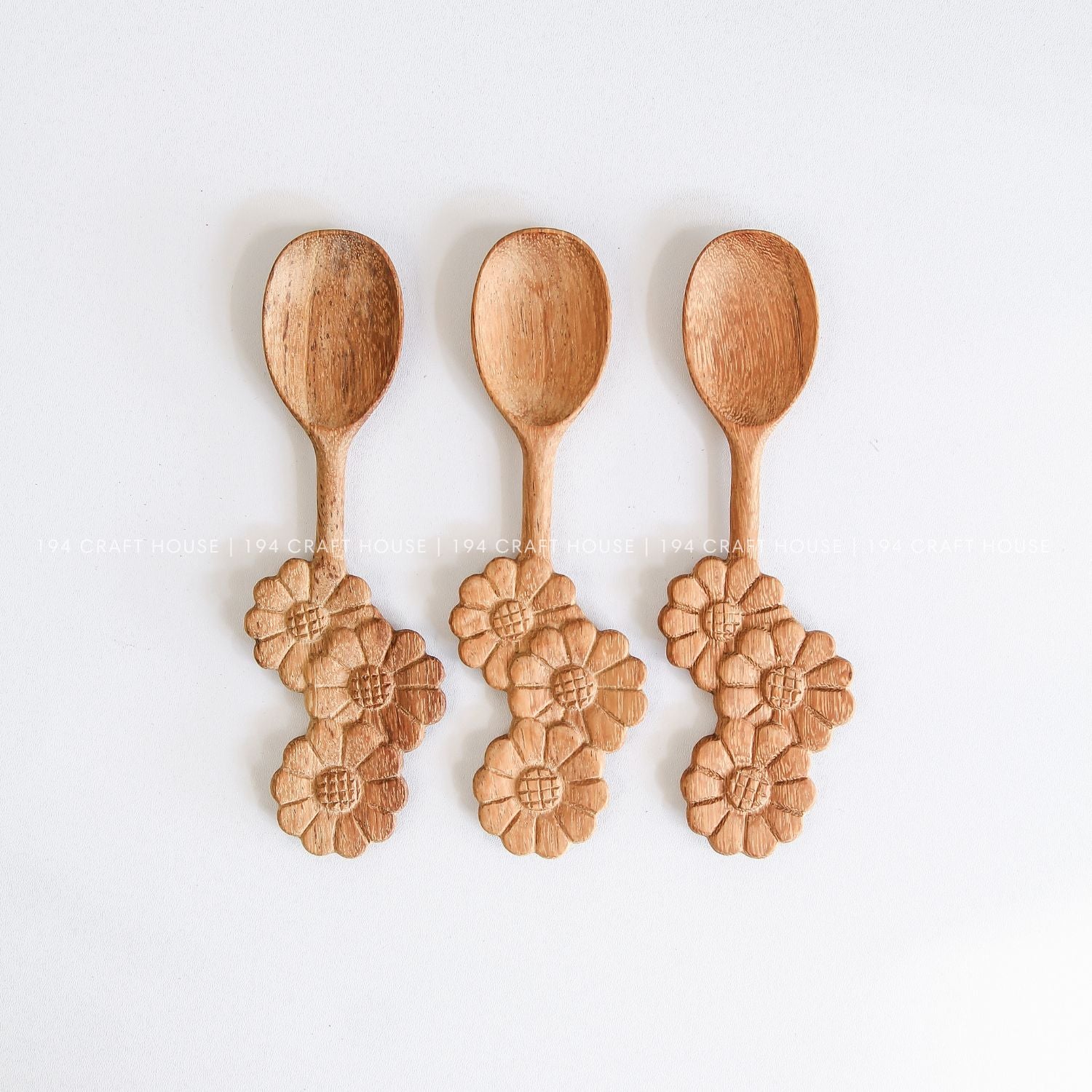 Set of three handcrafted wooden spoons with decorative three-flowers handles