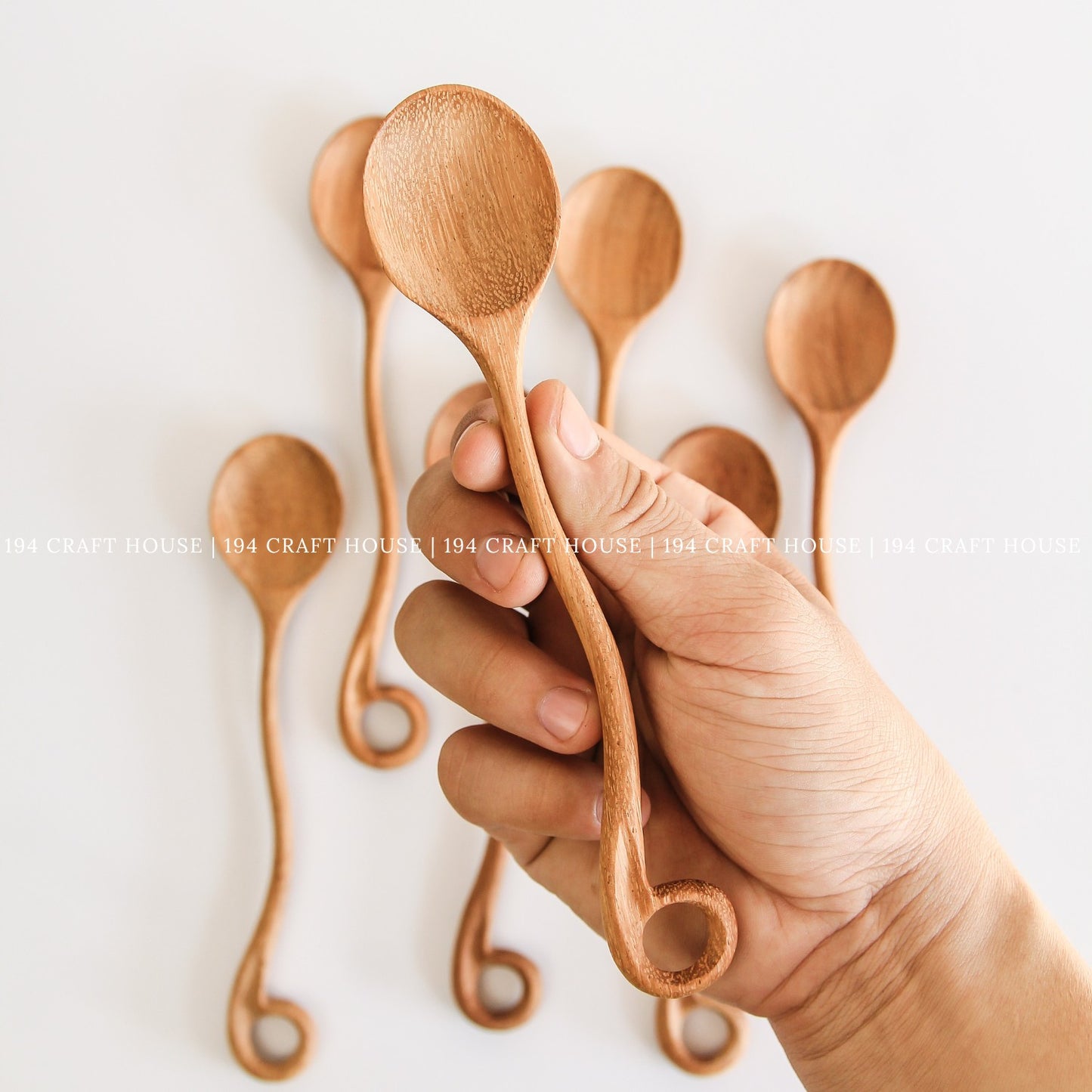 This handcrafted wooden spoon with a hole is shown in another product photo from 194 Craft House, designed for everyday kitchen cooking.