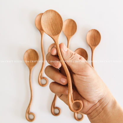 This handcrafted wooden spoon with a hole is shown in another product photo from 194 Craft House, designed for everyday kitchen cooking.