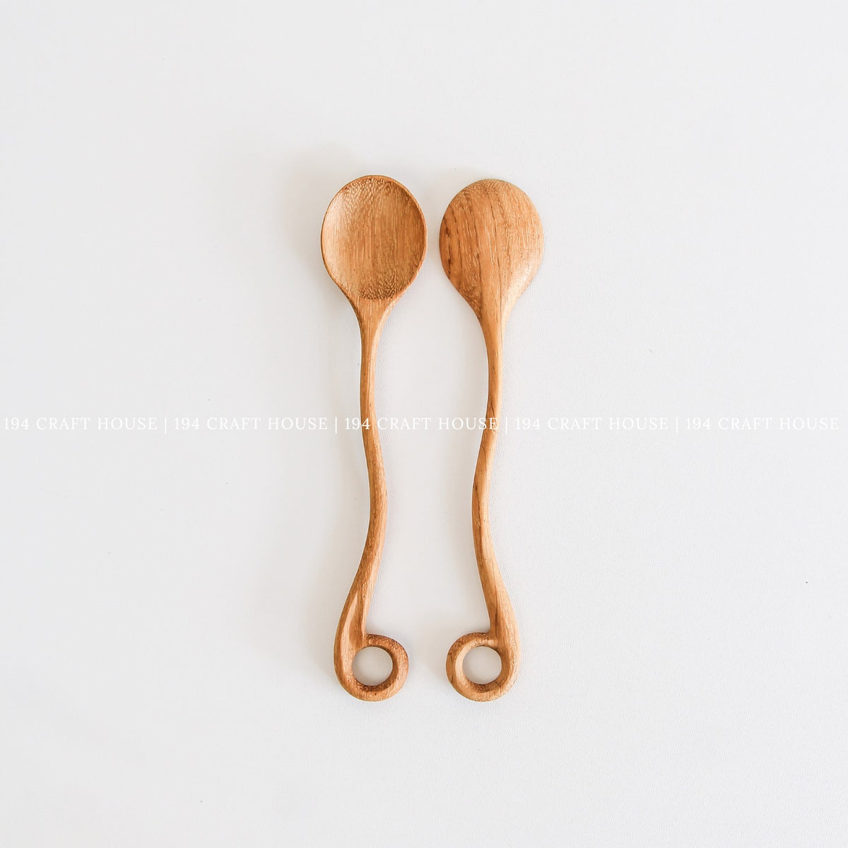 This handcrafted wooden spoon with a hole is another view from 194 Craft House, designed as a practical kitchen cooking utensil.