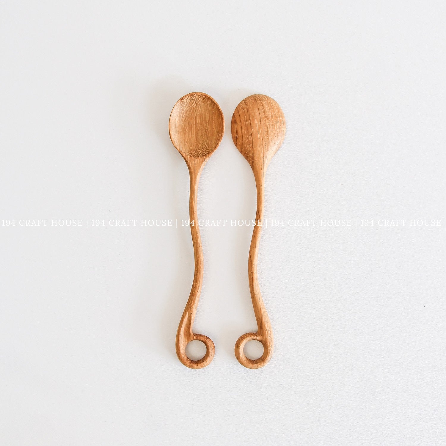 This handcrafted wooden spoon with a hole is another view from 194 Craft House, designed as a practical kitchen cooking utensil.