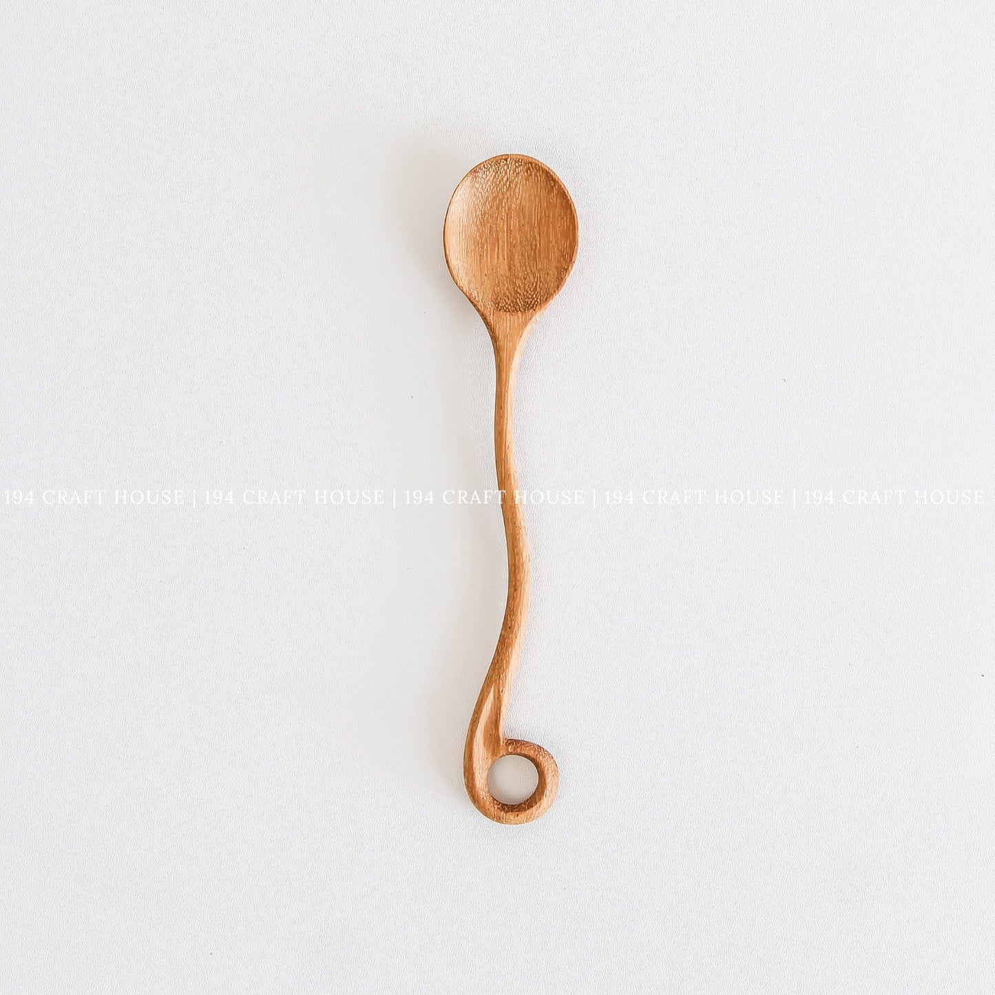 This handcrafted wooden spoon with a hole in the handle is a kitchen cooking utensil from 194 Craft House.