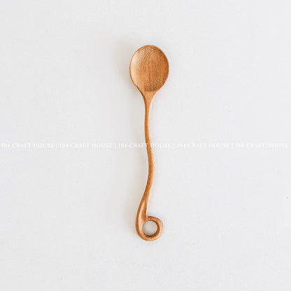 This handcrafted wooden spoon with a hole in the handle is a kitchen cooking utensil from 194 Craft House.