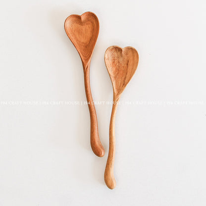 Set of handcrafted wiggly heart-shaped wooden spoons with natural wood grain