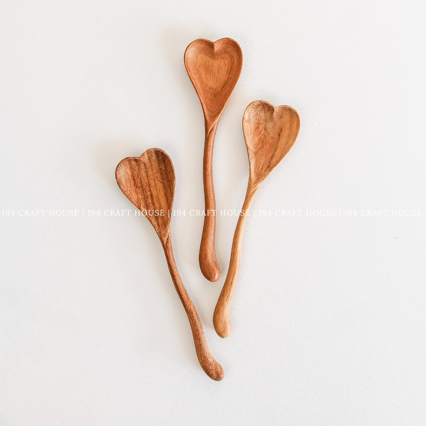 Collection of handcrafted wiggly wooden heart spoons for gifts and kitchen decor