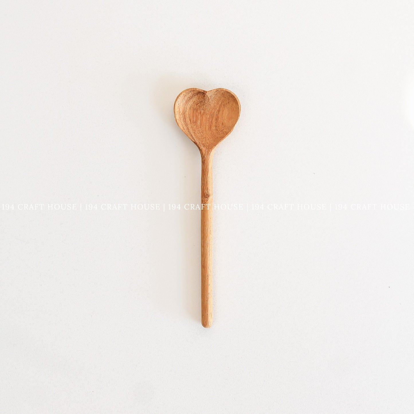 Handcrafted heart-shaped wooden spoon with a smooth straight handle