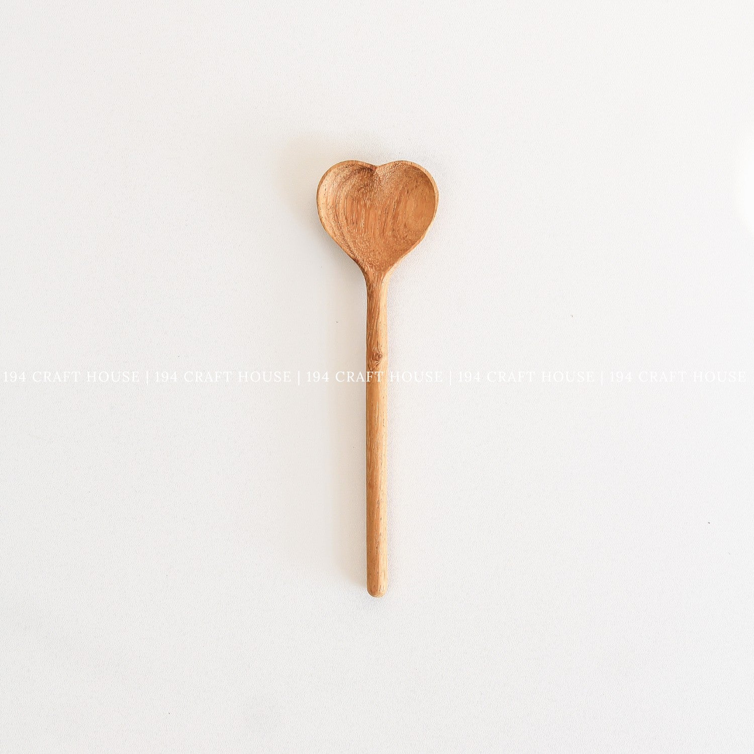 Handcrafted heart-shaped wooden spoon with a smooth straight handle