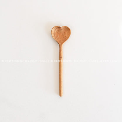Handcrafted heart-shaped wooden spoon with a smooth straight handle