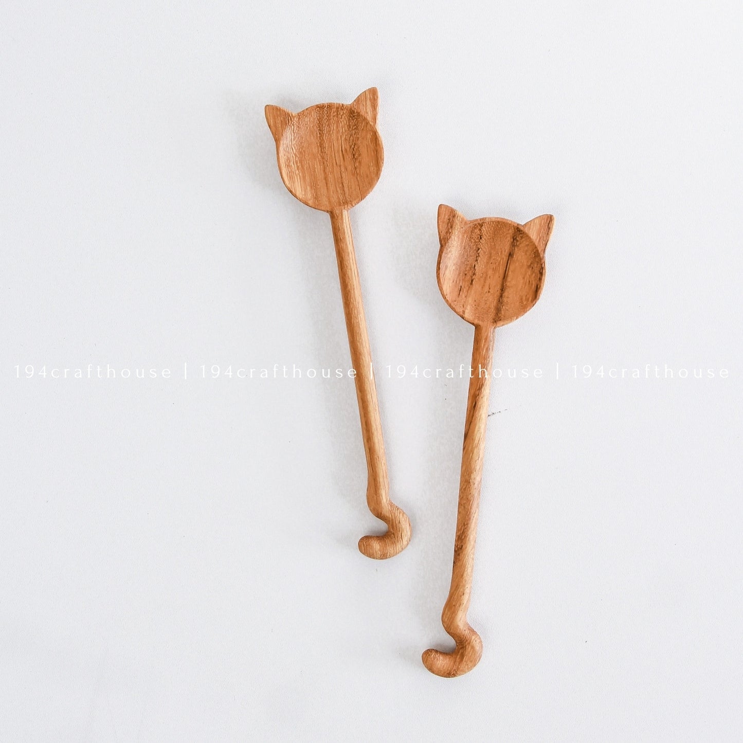 Pair of handcrafted cat-shaped wooden spoons with natural wood grain