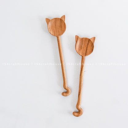 Pair of handcrafted cat-shaped wooden spoons with natural wood grain