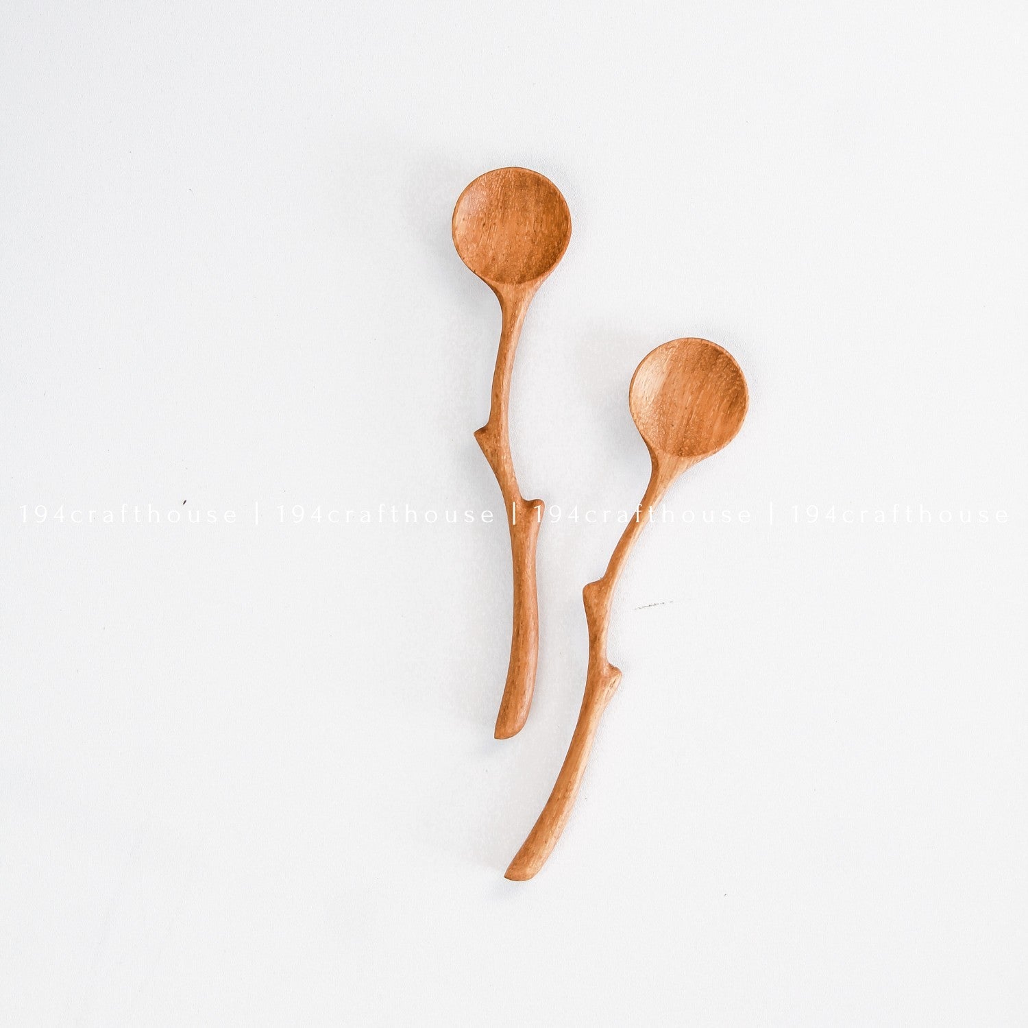 Pair of handcrafted branch handle wooden spoons with unique natural curves