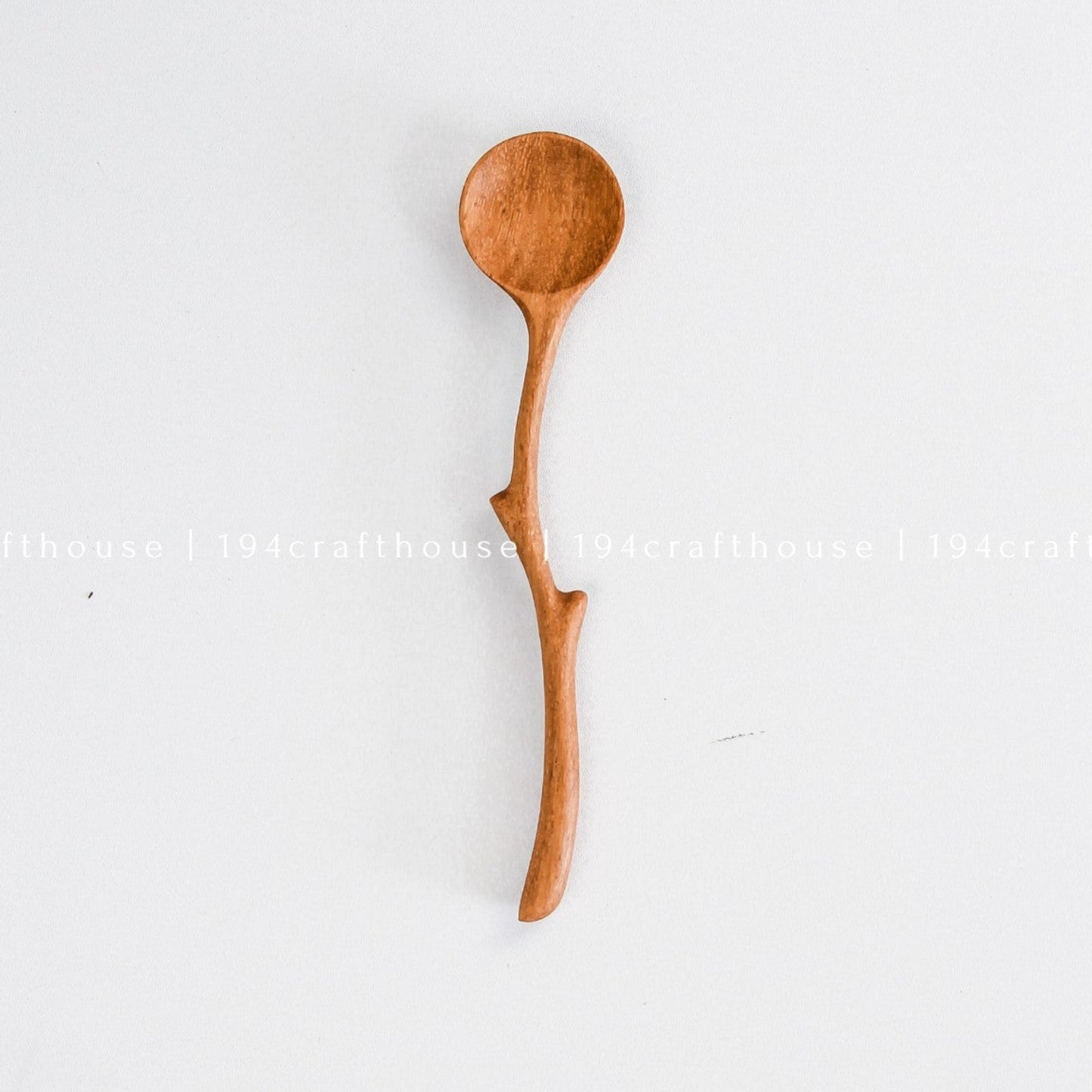 Handcrafted branch handle wooden spoon with a natural curved design and rounded bowl