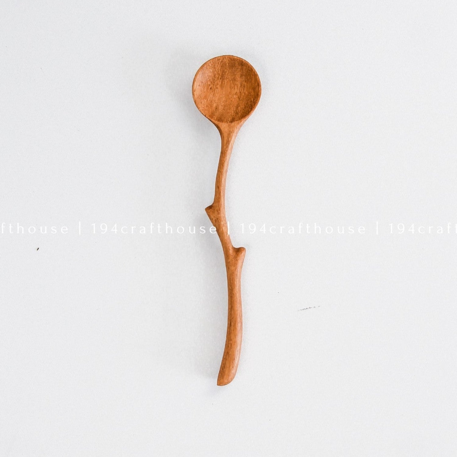 Handcrafted branch handle wooden spoon with a natural curved design and rounded bowl