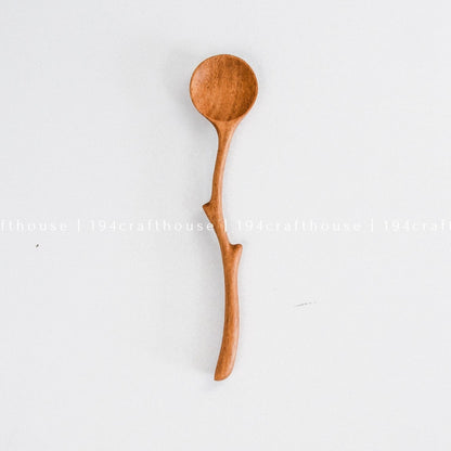 Handcrafted branch handle wooden spoon with a natural curved design and rounded bowl