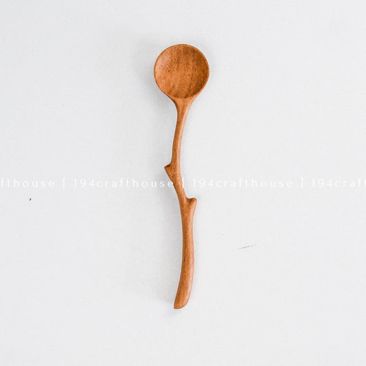 Handcrafted branch handle wooden spoon with a natural curved design and rounded bowl