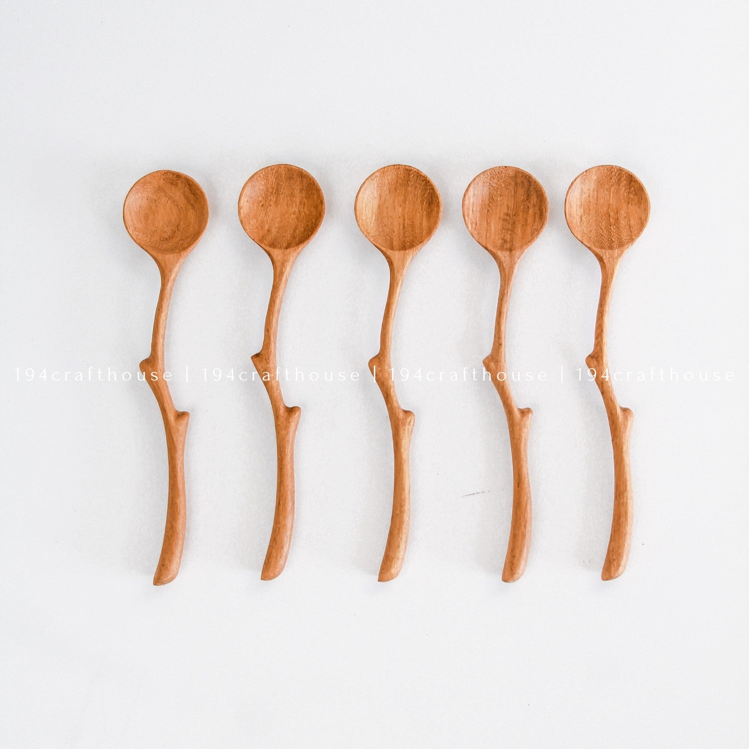 Collection of handcrafted branch handle wooden spoons showing natural variations