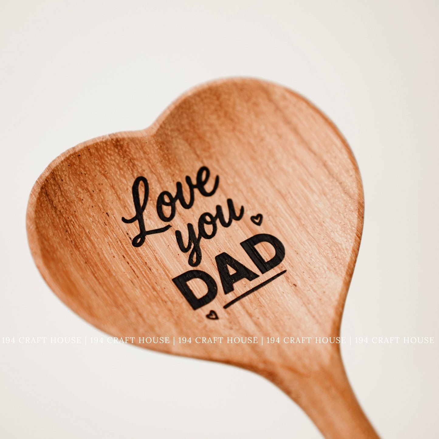 Engraved heart-shaped wooden spoon with Love You Dad message as a personalized gift for Dad
