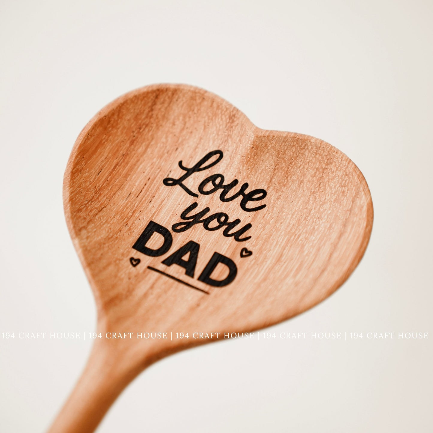 Personalized heart-shaped wooden spoon engraved with Love You Dad for Father's Day