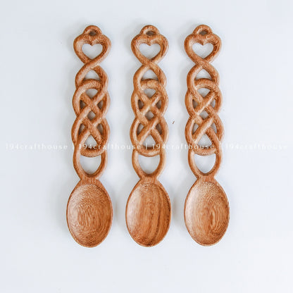 Set of handcrafted Welsh love spoons with carved hearts and decorative chain-link designs
