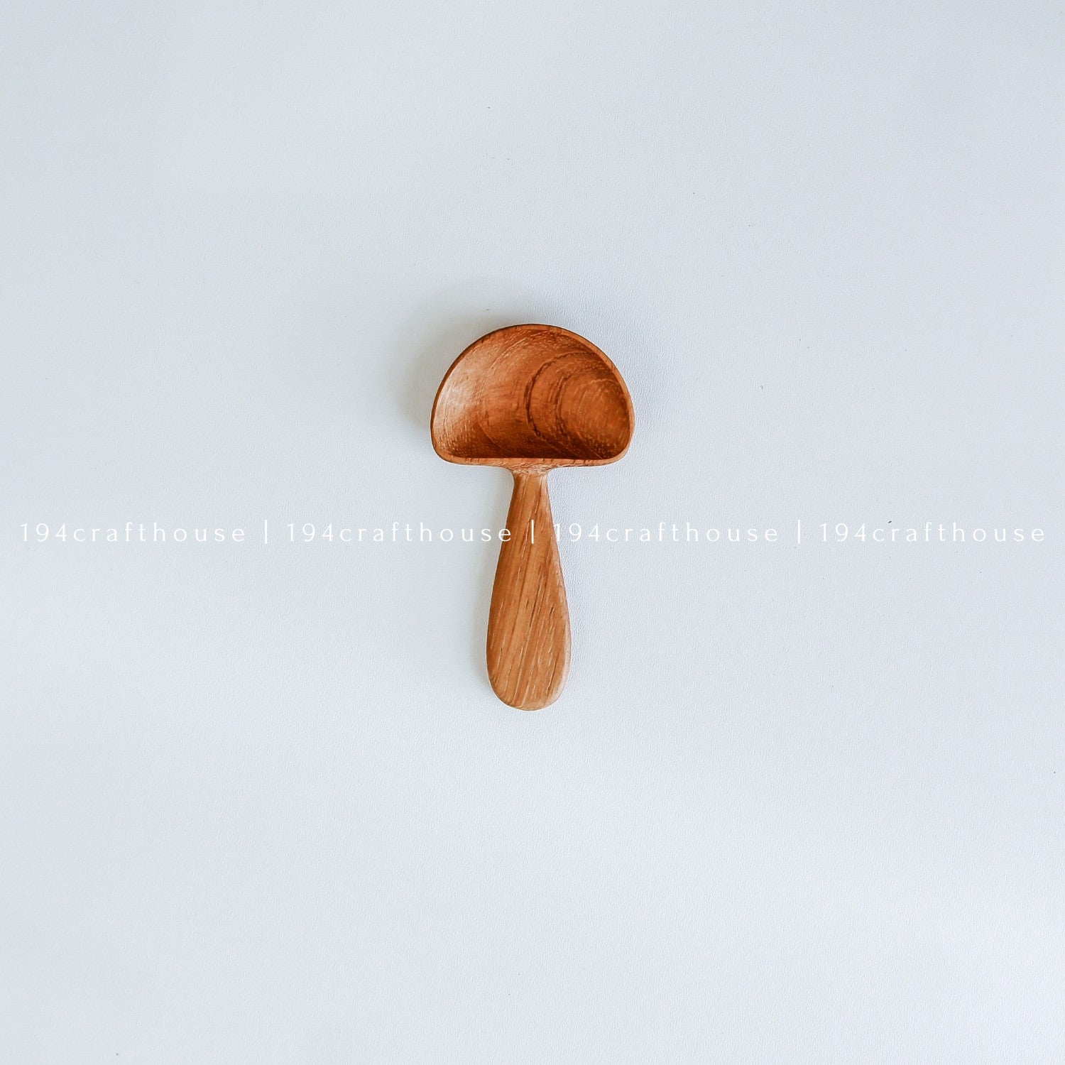 Handcrafted wooden mushroom spoon with a rounded mini scoop and short stem handle