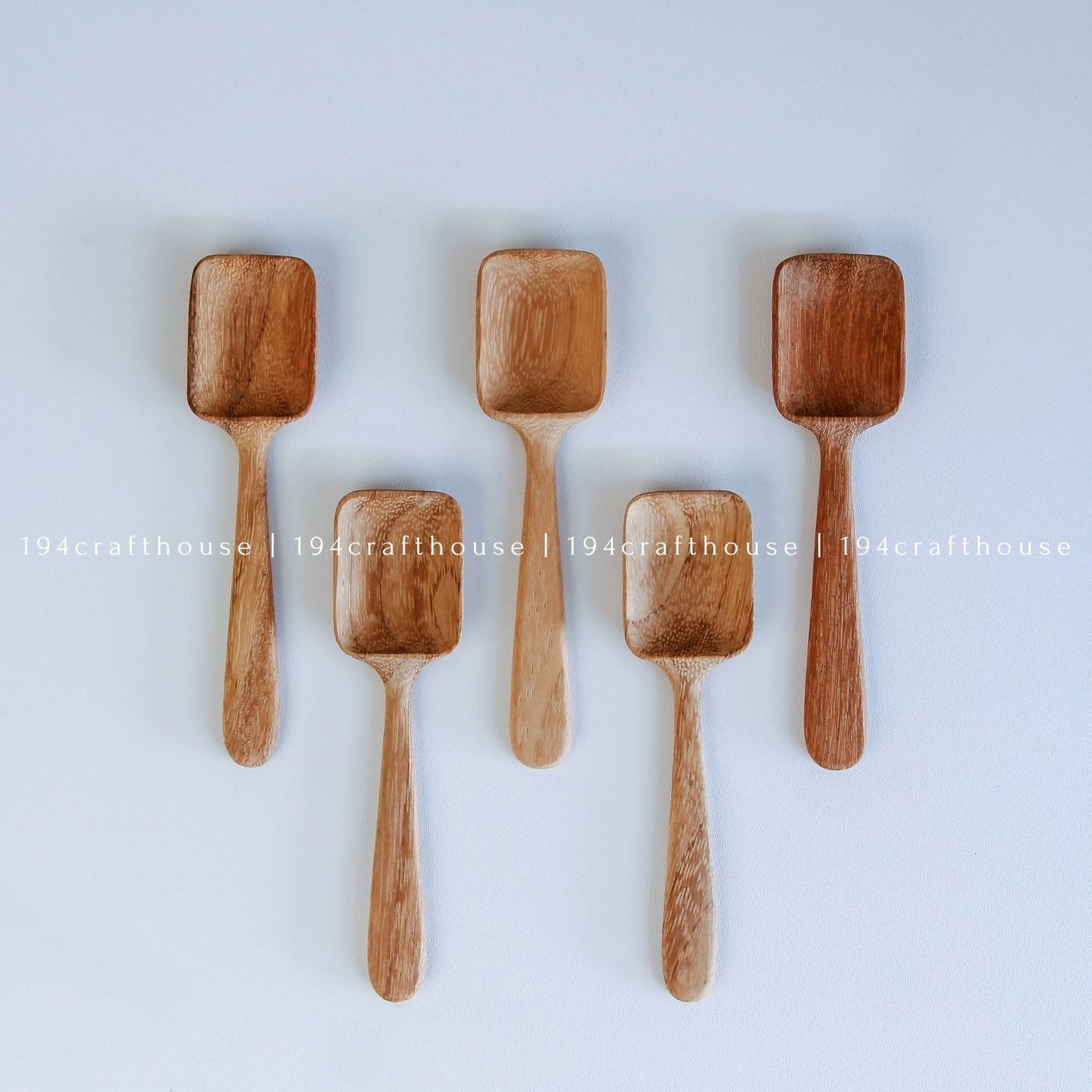 Set of five Doussie wood measuring spoons with square scoops in assorted sizes