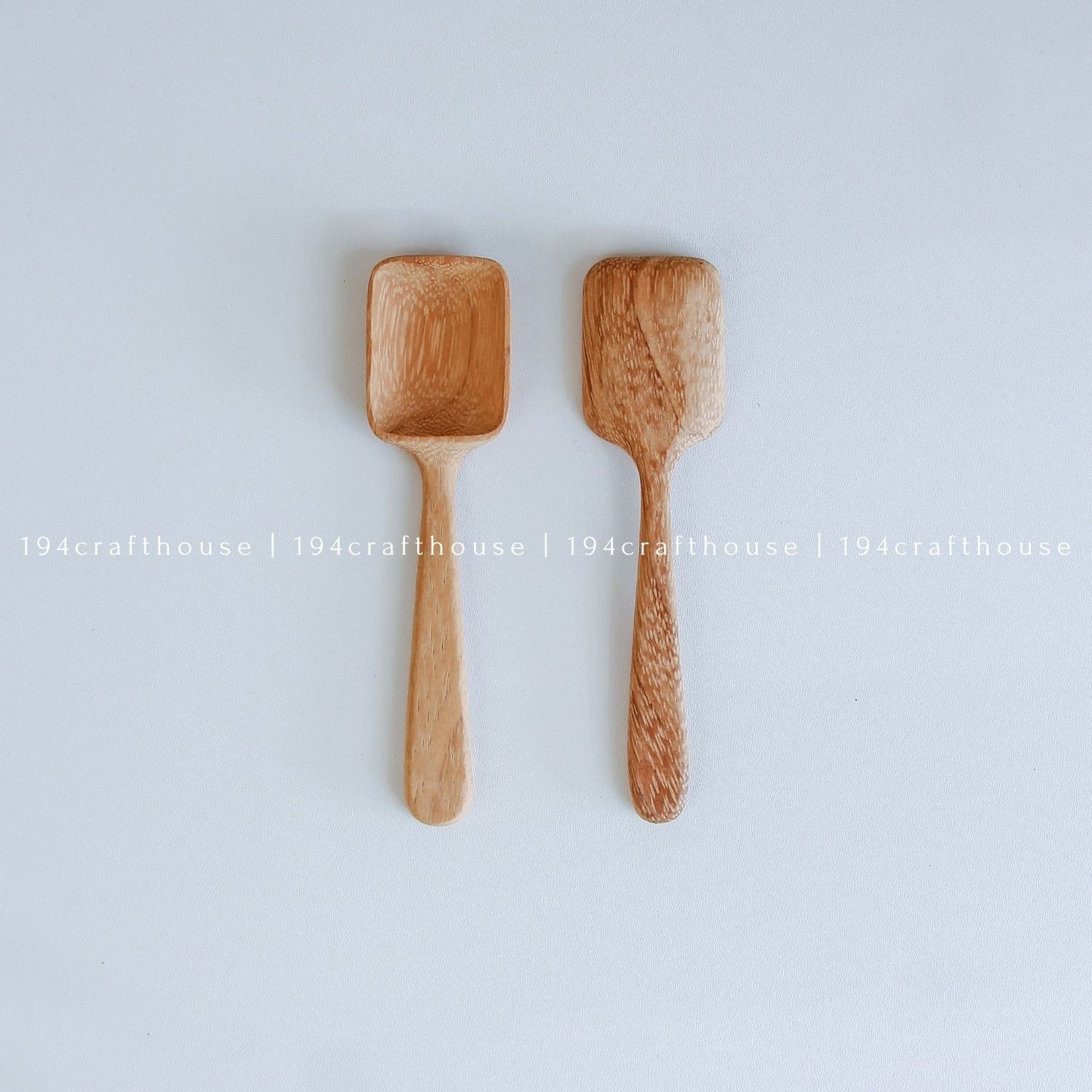 Two handcarved Doussie wood measuring spoons with square scoops in different sizes