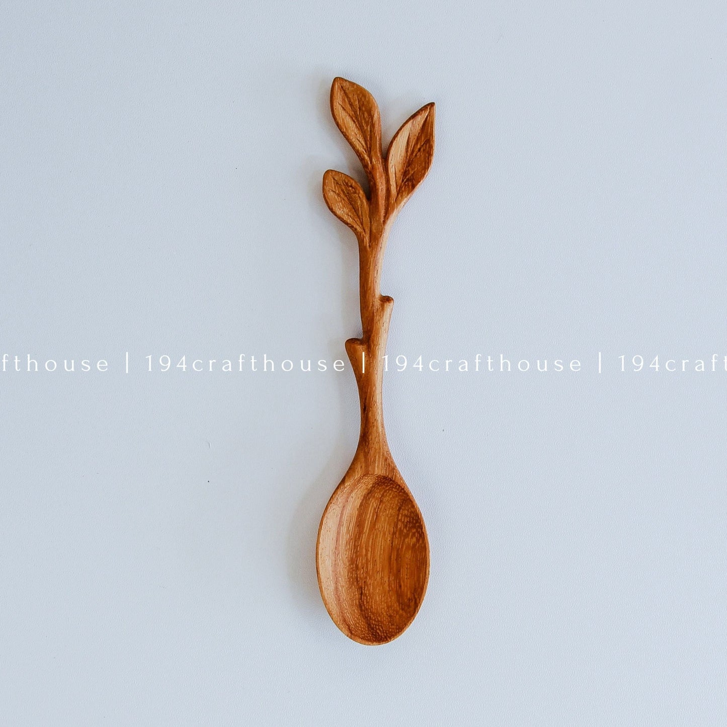 Hand-carved leaf handle wooden spoon with sculpted branch and leaf details