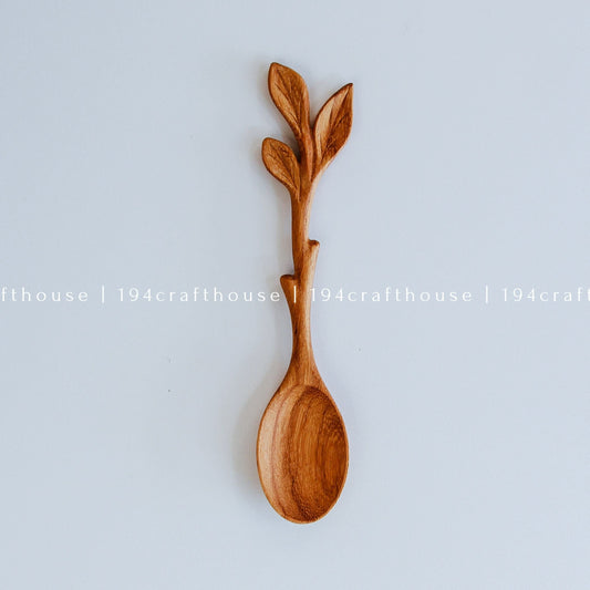 Hand-carved leaf handle wooden spoon with sculpted branch and leaf details