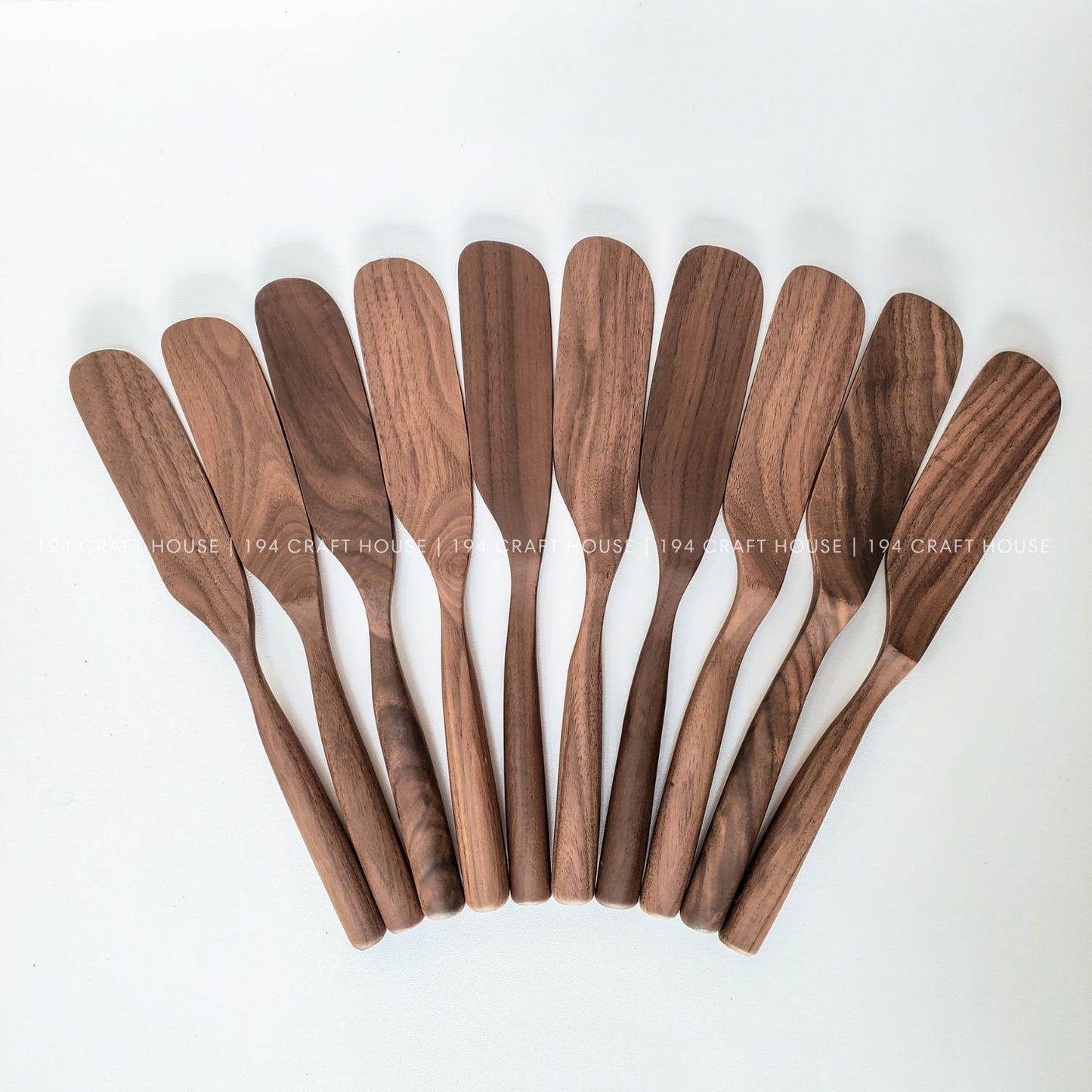 Set of handcrafted walnut wooden spreader knives with natural wood grain variations
